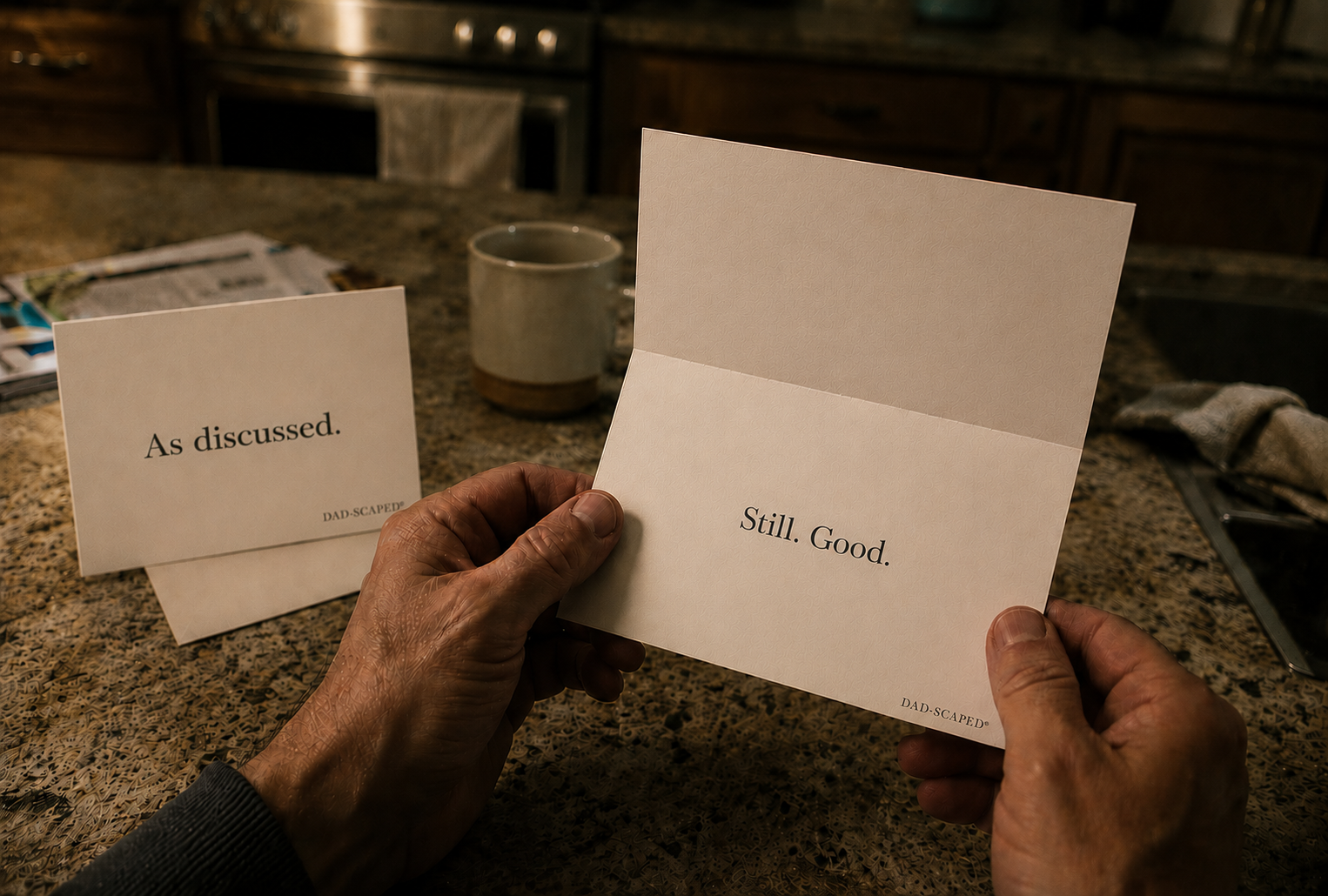 Two Dad-Scaped cards on a kitchen counter.